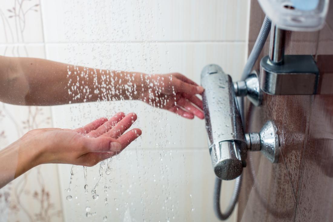 womans hands under shower