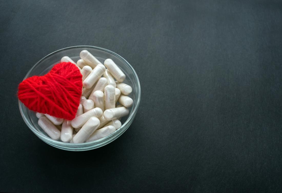 bowl of pills with heart made of string
