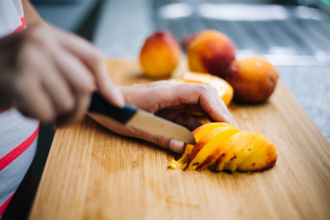 A peach being sliced which contains D mannose