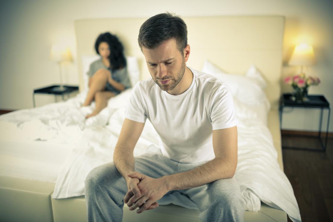 Anxious man sat on the end of his bed wondering if erectile dysfunction can be reversed