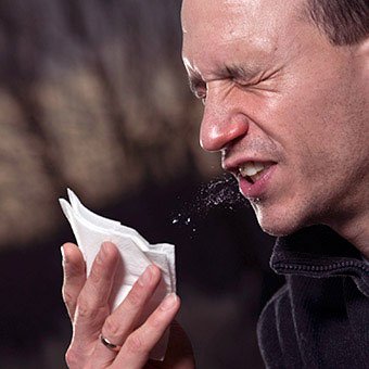 A man sneezes.