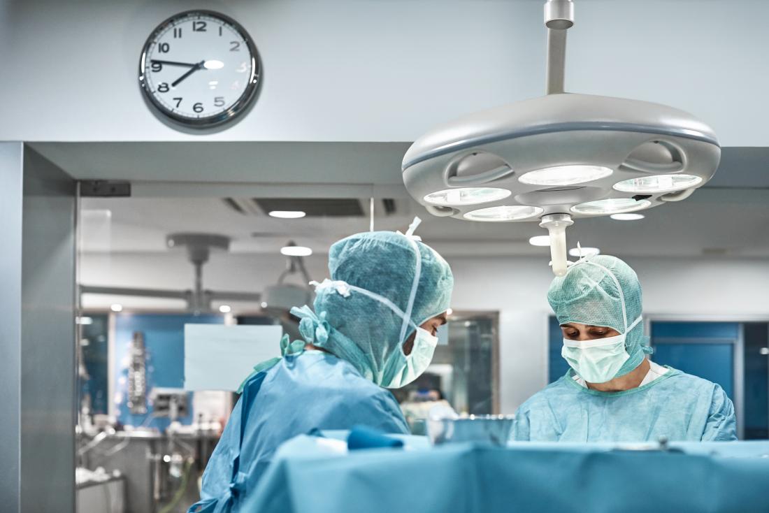 Surgeons in an operating theatre working on a penile implant