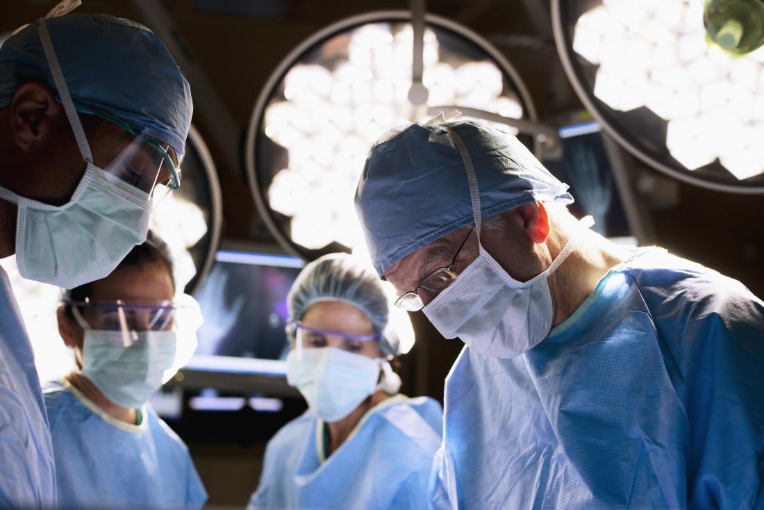 surgeons in operating theatre performing crohn s surgery