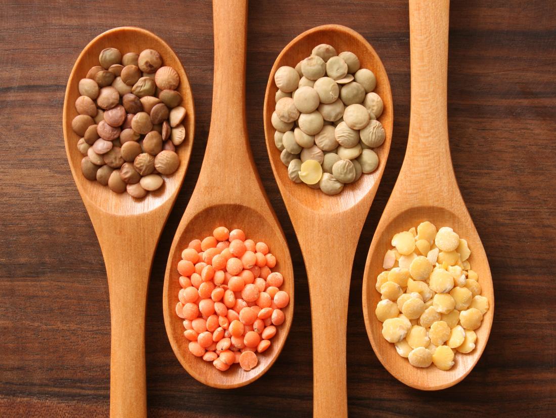 Different lentils on spoons which are iron-rich foods for vegetarians