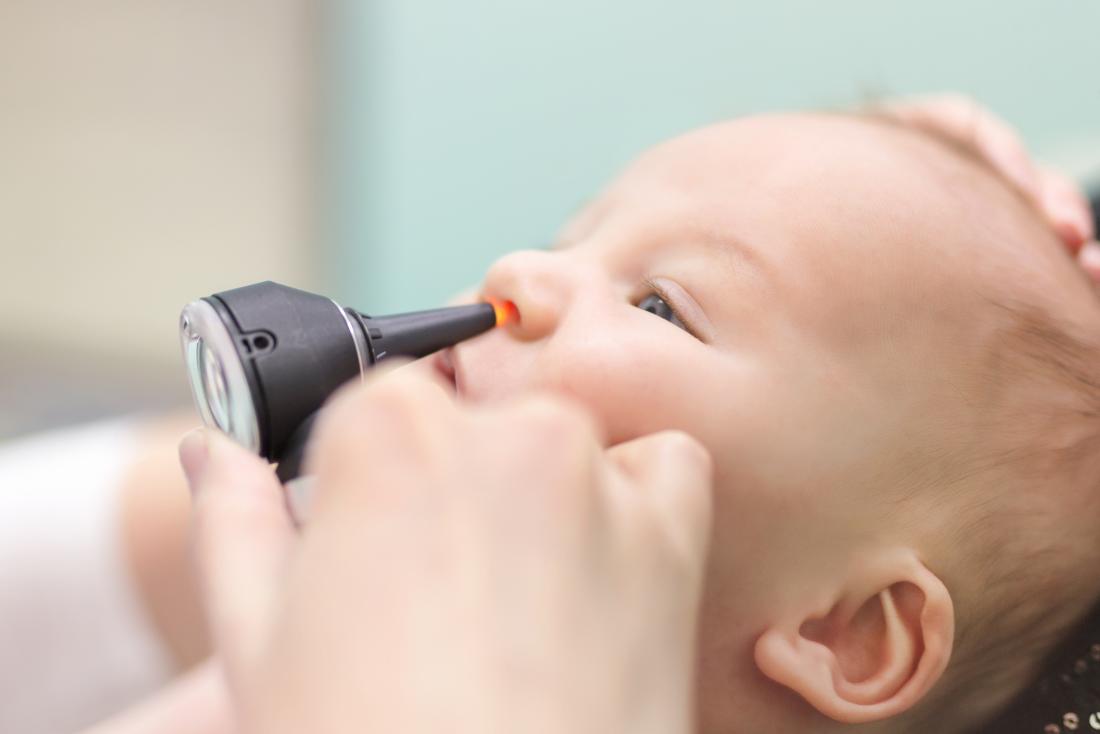 Baby having nose and sinus inspected by doctor