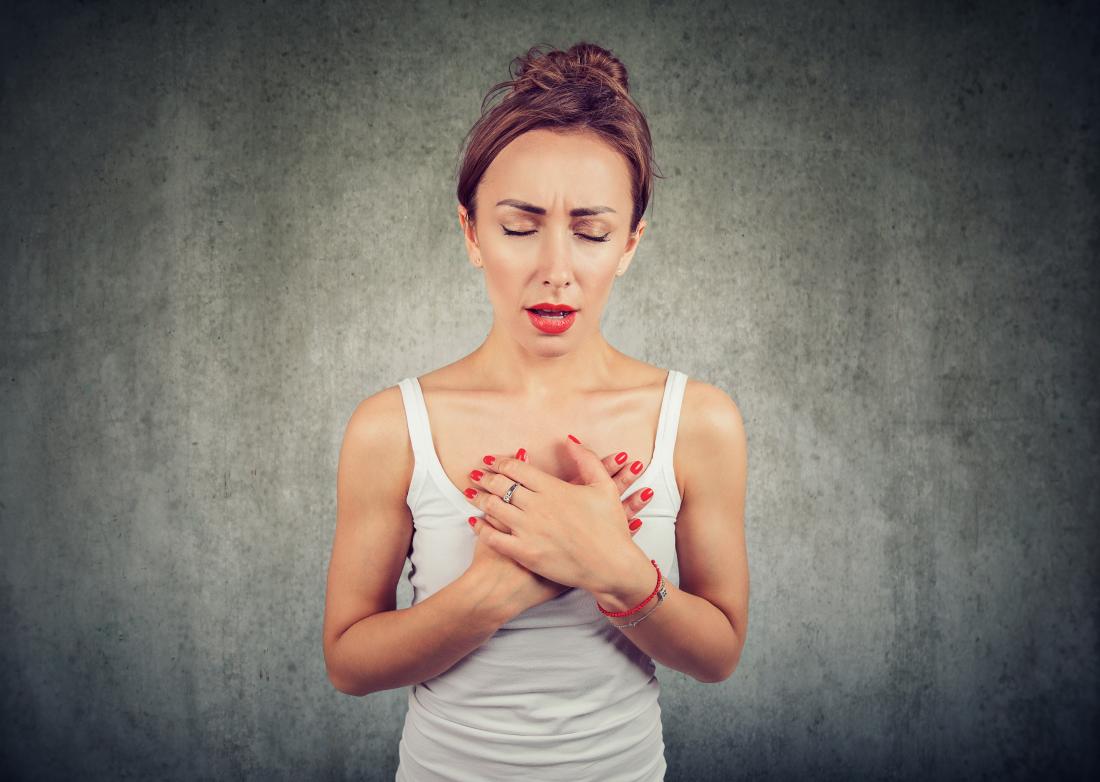 Woman holding her chest due to COPD