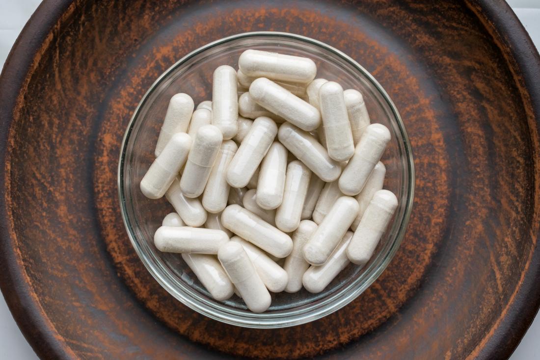 Kava kava supplement capsules in bowl