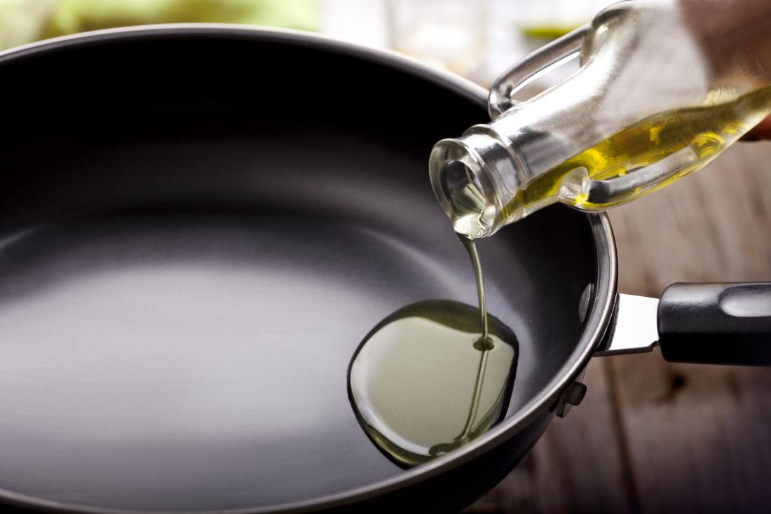 Oil being poured into a pan