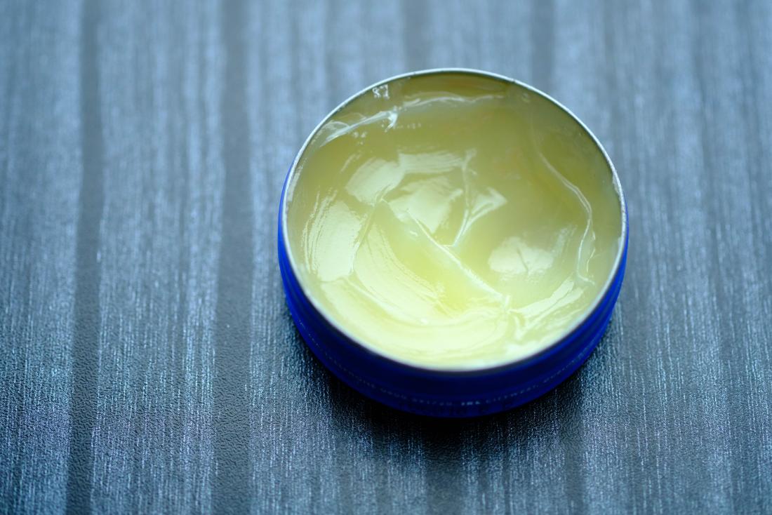 vasaline or petroleum jelly in pot on table