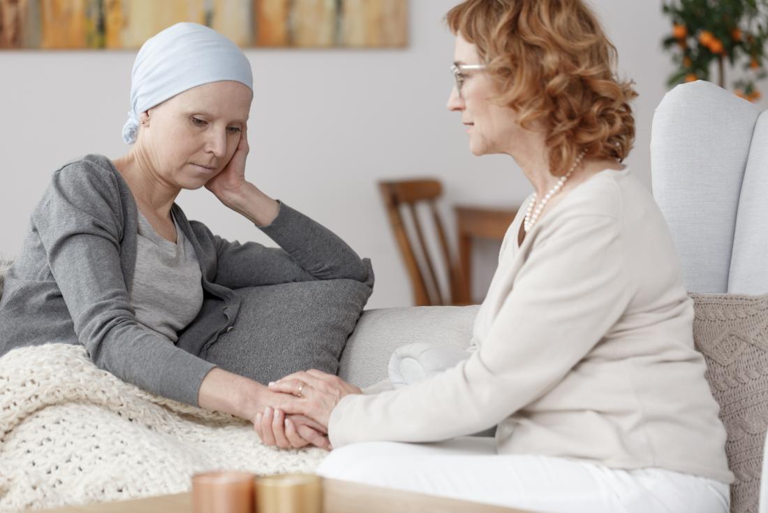 Woman being comforted after chemotherapy
