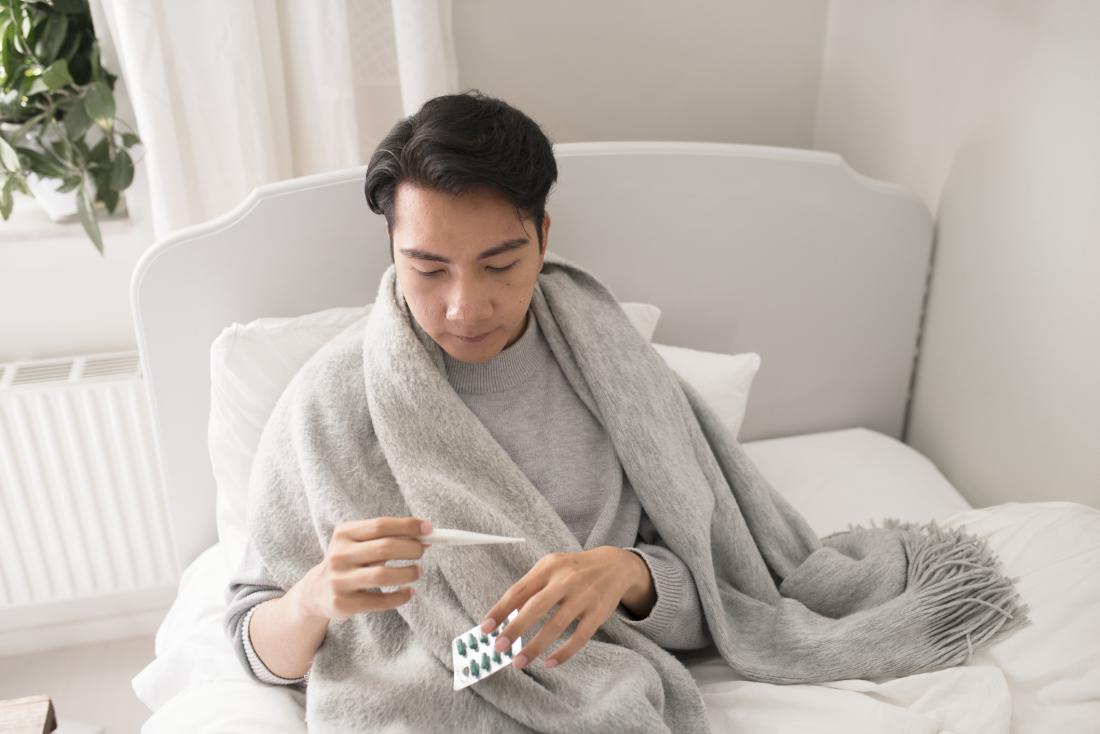 man with temperature feeling ill