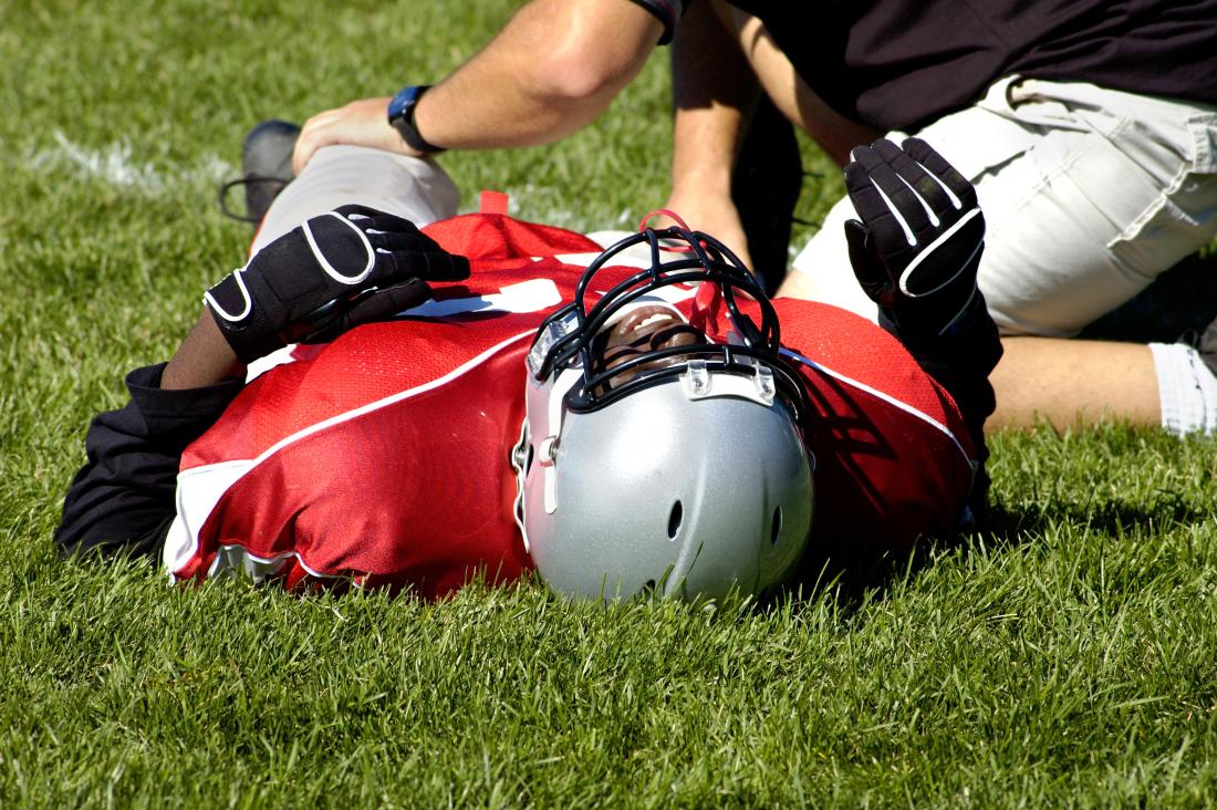 Football player with injured knee caused by lateral collateral ligament sprain