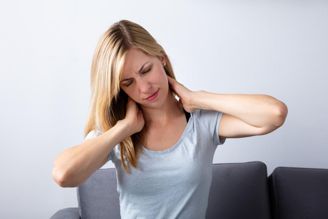 Woman holding her neck in pain due to wry neck