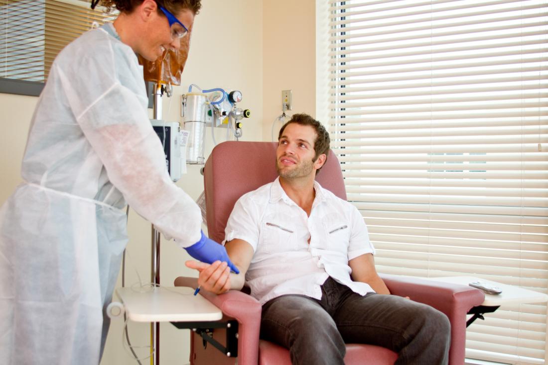 Person sitting in chair receiving infusion treatment for Crohn's