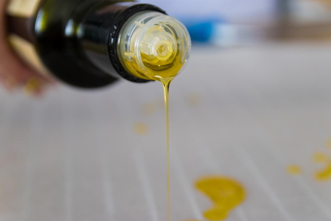 Olive oil being poured from a bottle