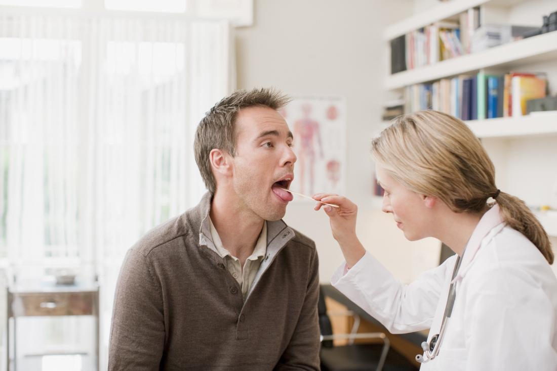 doctor examining tongue