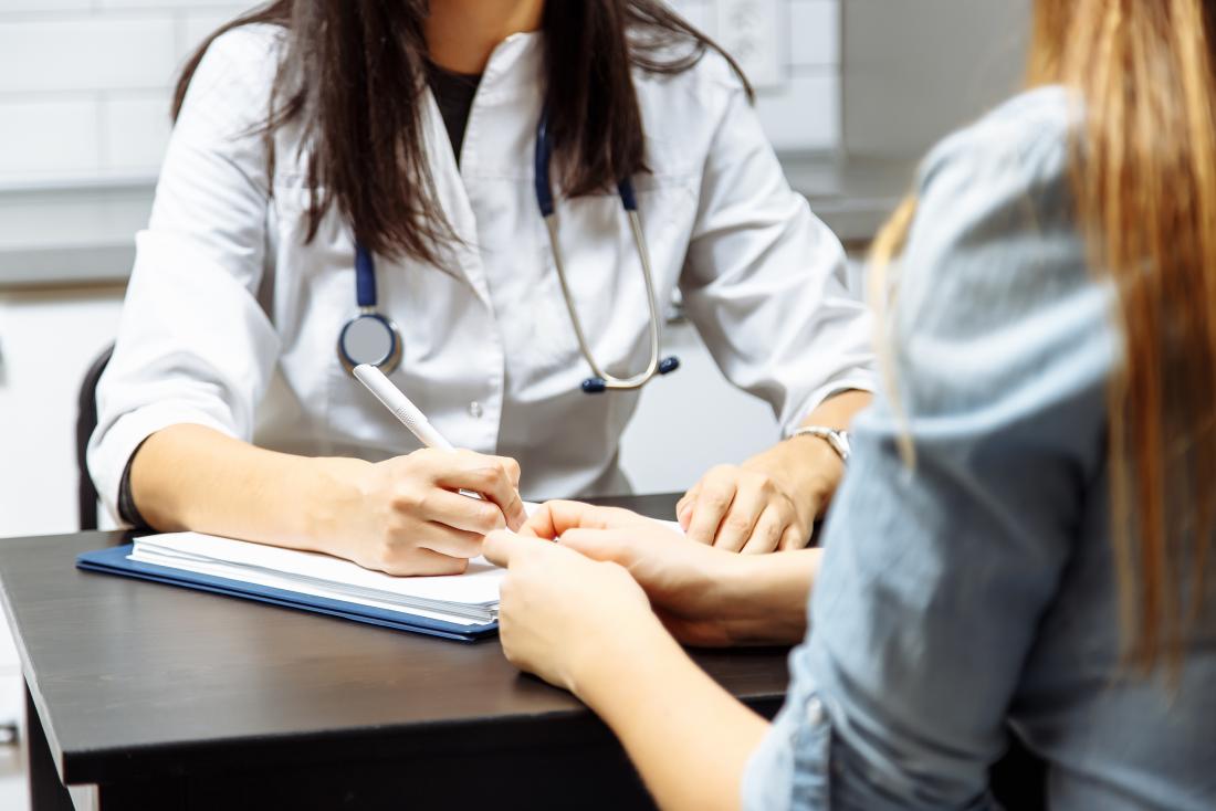 Doctor writing notes on a patient