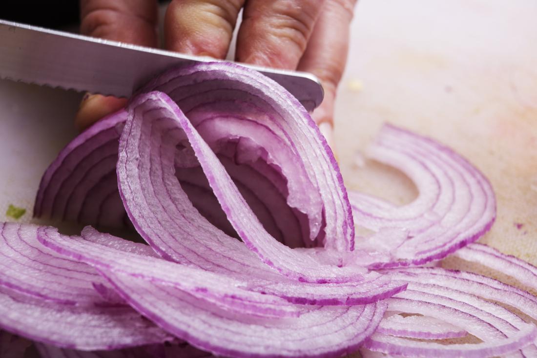 Red onion being cut<!--mce:protected %0A-->