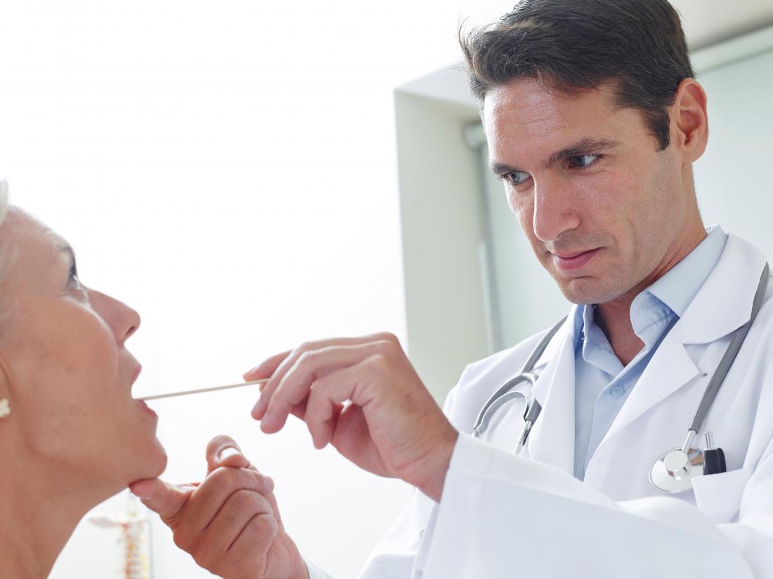 doctor looking in female patients throat