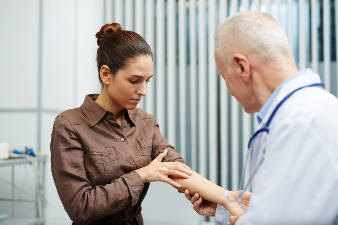 Doctor checking patients skin for psoriasis remission
