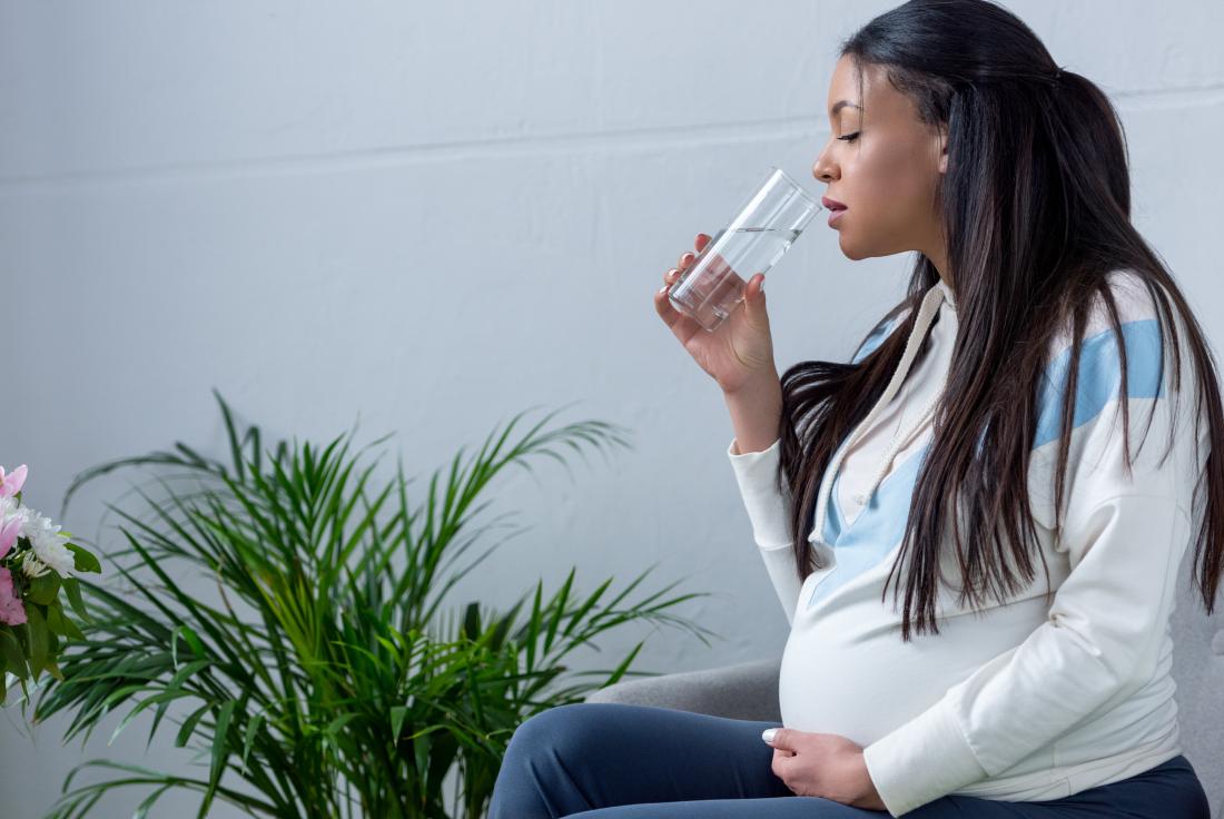 pregnant woman drinks water