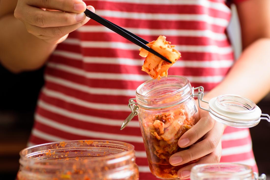 kimchi being taken out of a jar