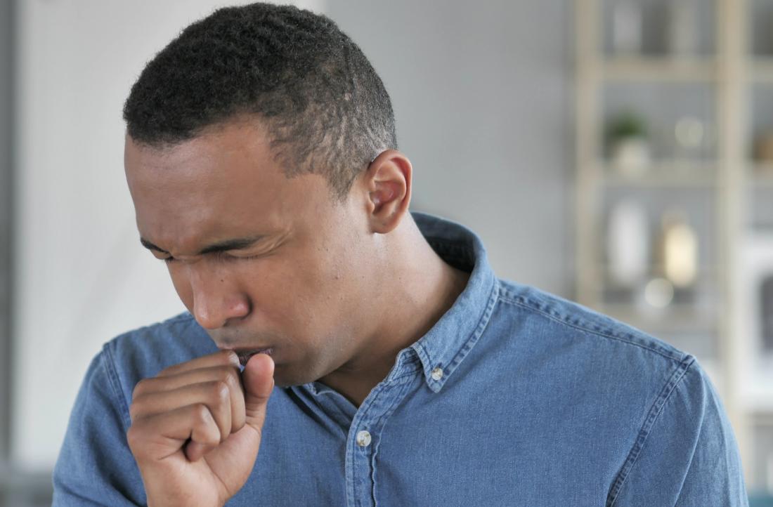 Man coughing into fist
