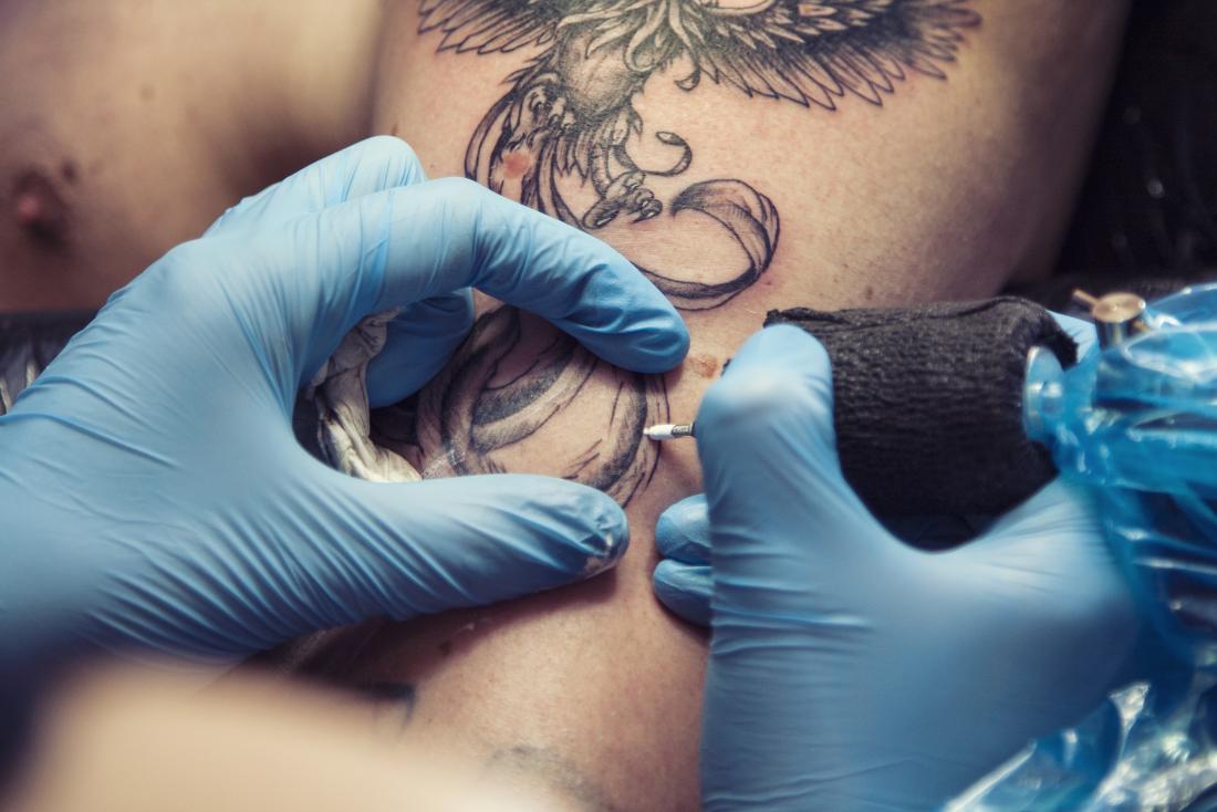 man being tattooed