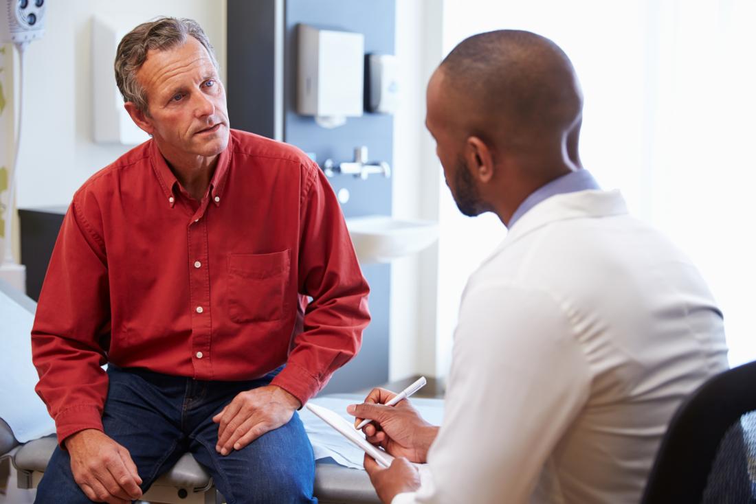 man discussing chronic prostatitis with male doctor in office