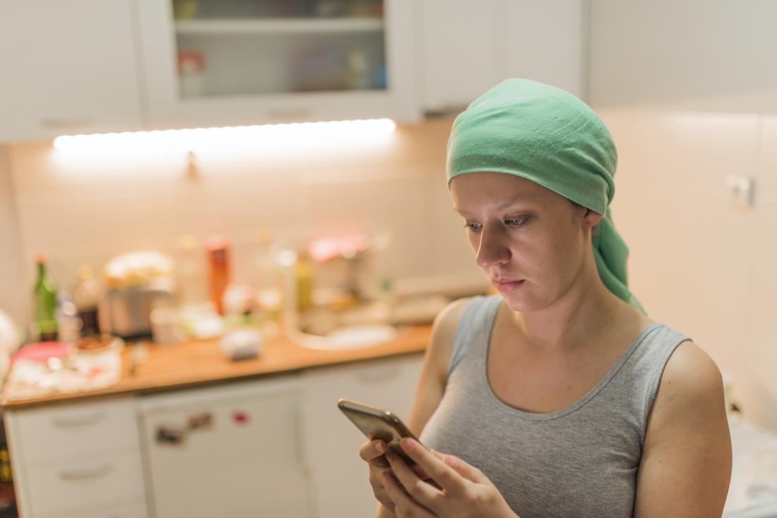 cancer survivor checking her phone