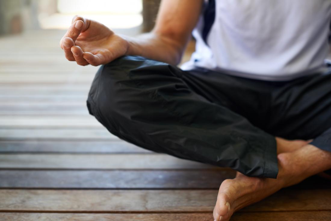 Man cross-legged and meditating