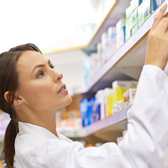 A pharmacist fills a prescription for head lice.