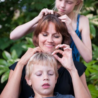 A family checks each other's hair for lice.