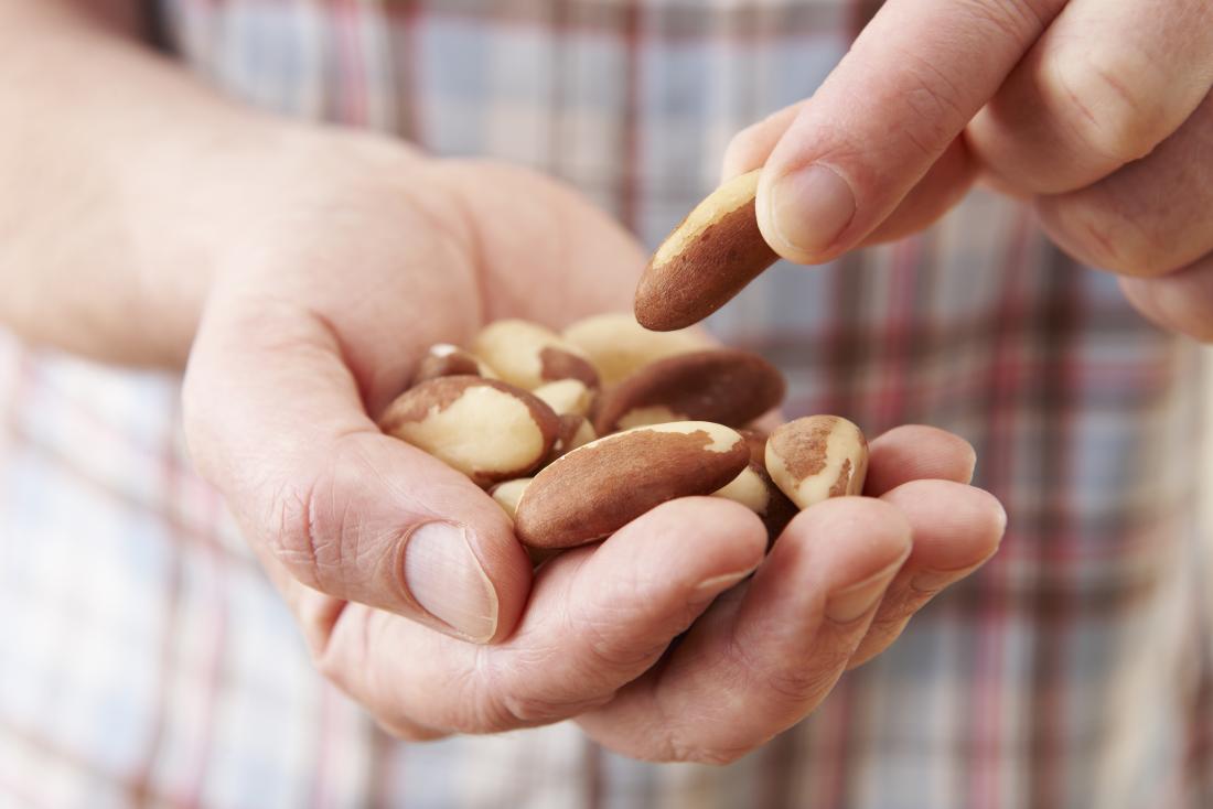 brazil nuts in a mans hand which are part of hypothyroidism diet