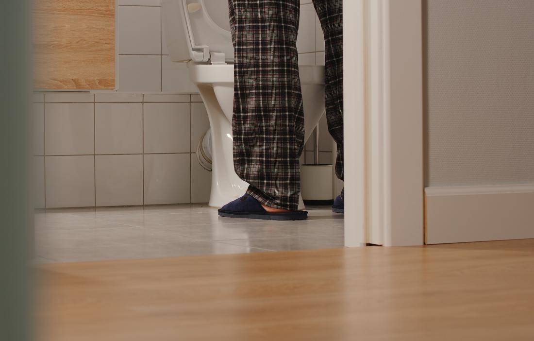 man standing in front of toilet