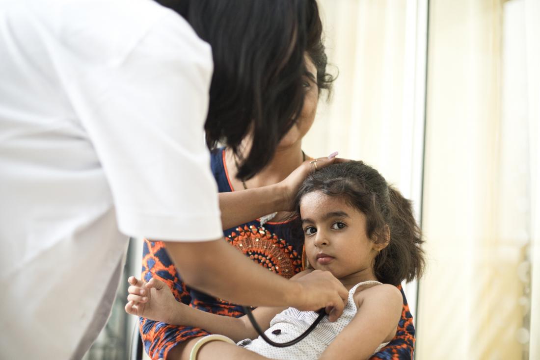 young girl being examined by doctor