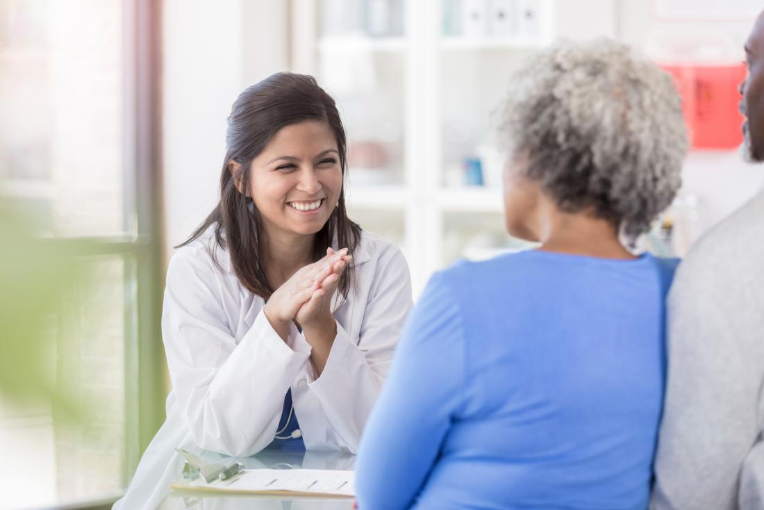 Female doctor speaking to mature senior woman