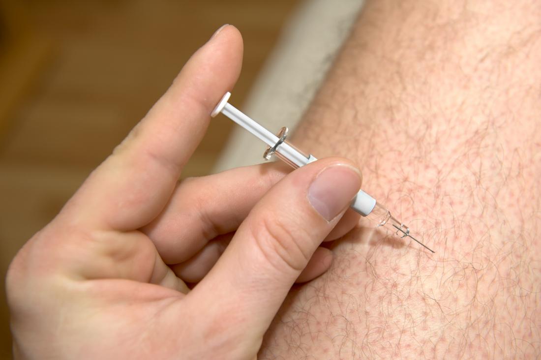 person being given injection into thigh