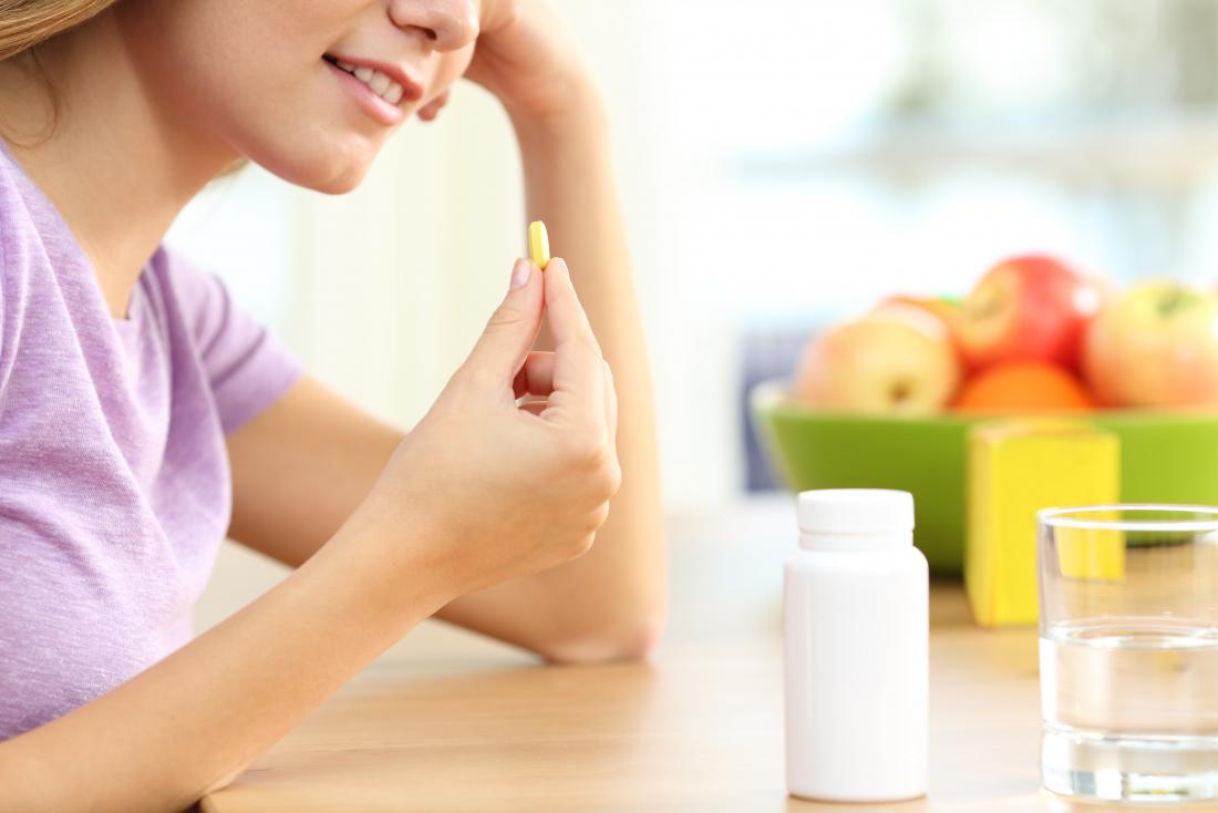 girl taking a supplement
