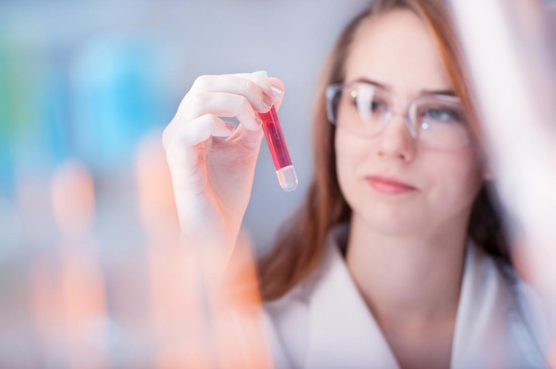 scientist looking at blood sample