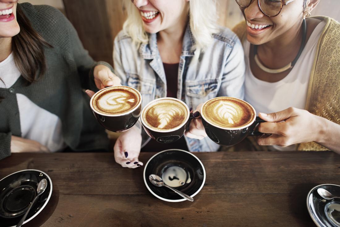 female friends drinking coffee in cafe