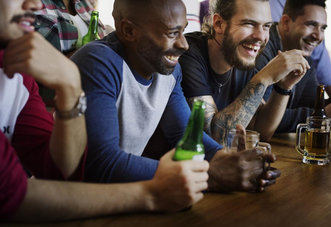 group of male friends drinking in a bar