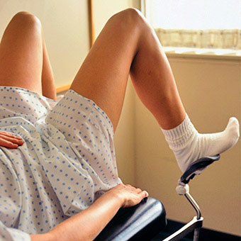 A woman at the gynecologist waiting to be examined.
