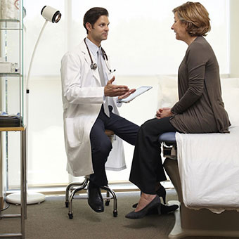 A doctor talks to a female patient.
