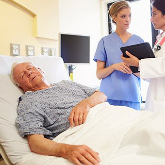 A doctor and nurse discussing complications of a senior patient in the hospital.