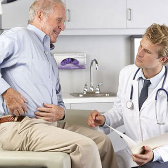 A doctor examines a patient with hip bursitis.