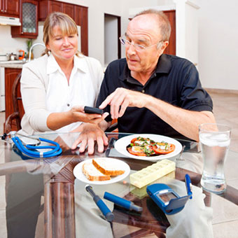 A dietician discussing food options with a senior kidney patient.