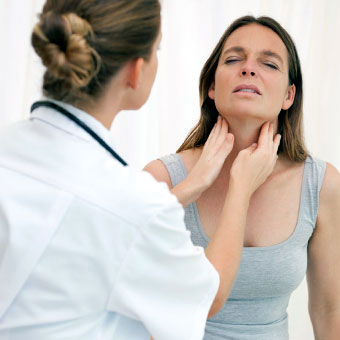 A doctor examines a woman's lymph nodes (glands).