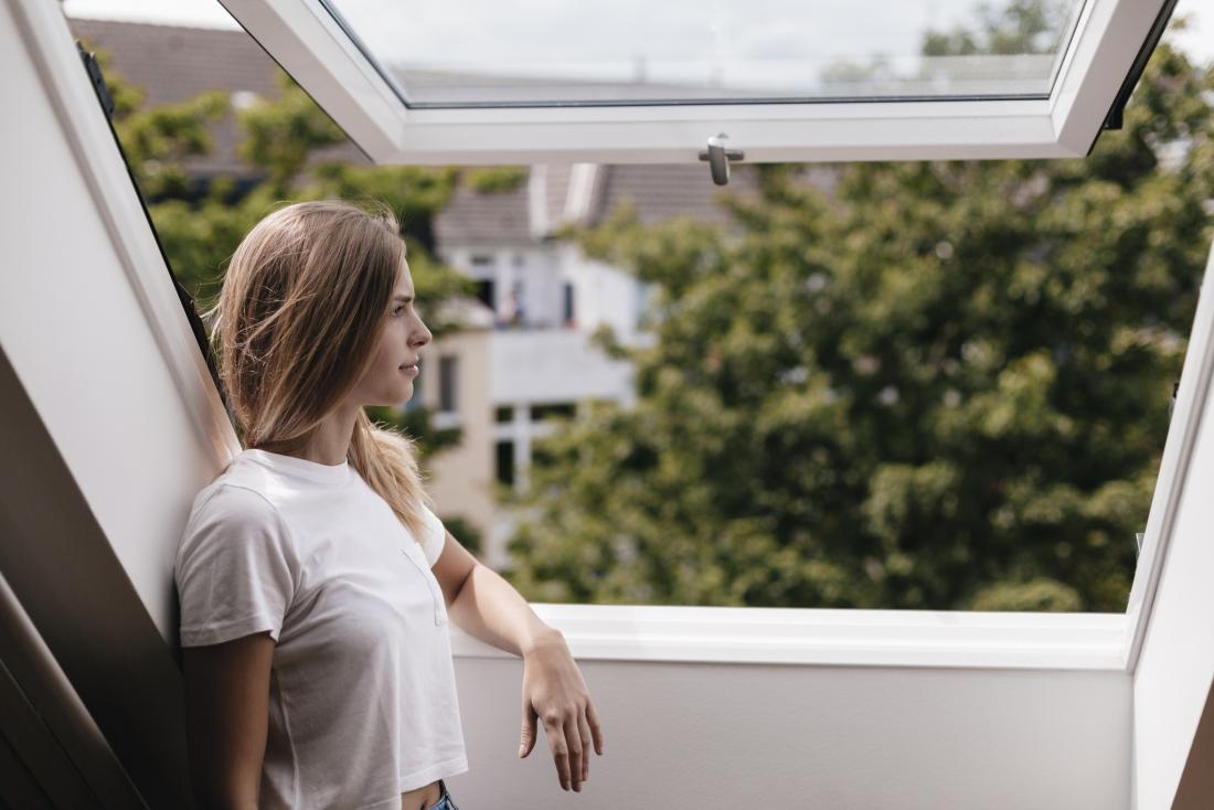 woman looking out the window at view of nature