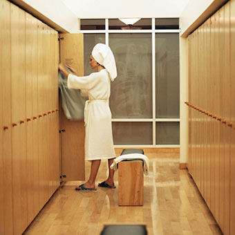 A woman changes in a locker room after a shower.